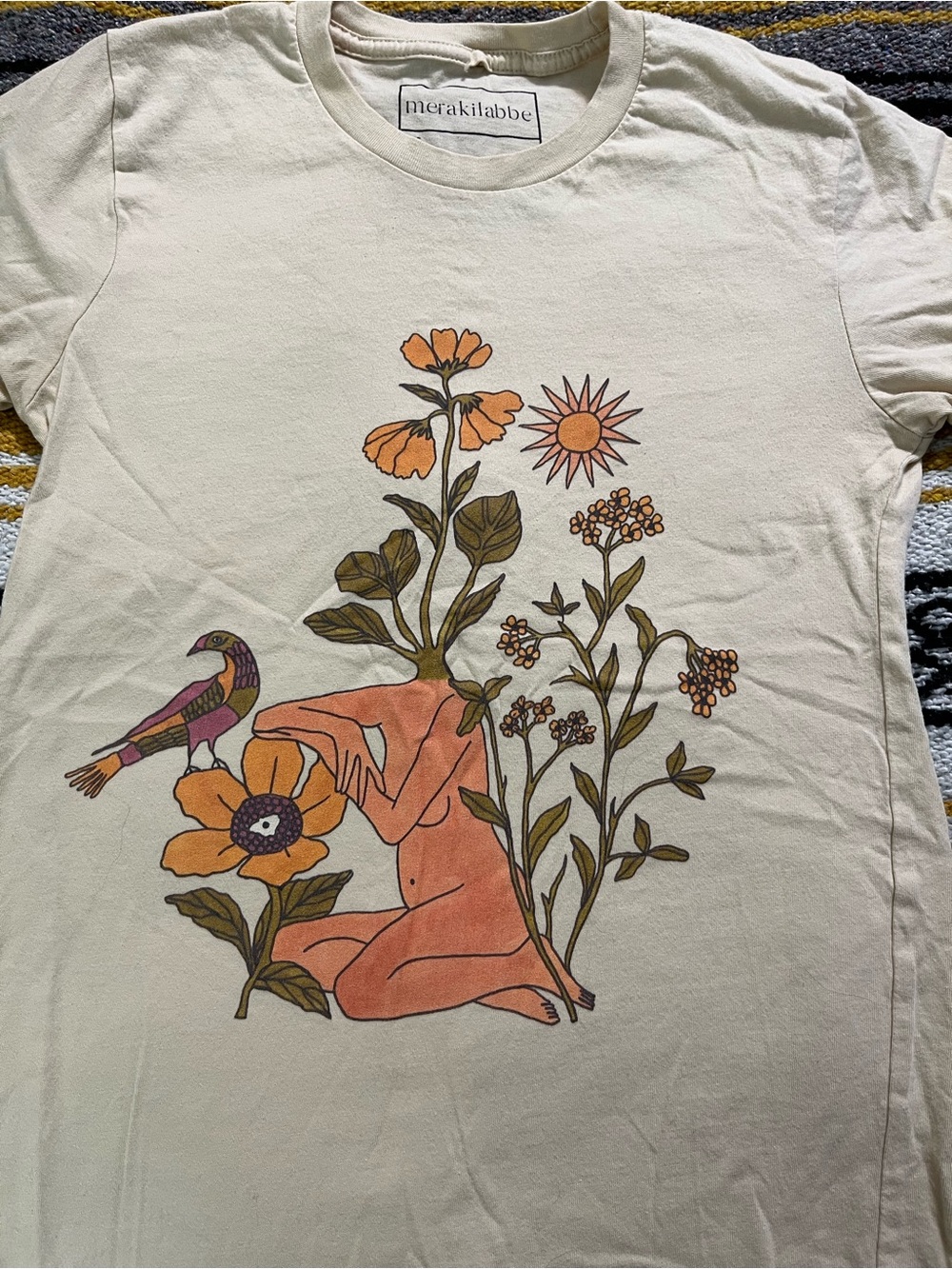Artist Merakilabbe cream tee with orange floral and multicolor bird graphic